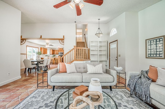 6355 N Cleo Ave, Fresno, CA 93722 - living area featuring ceiling fan, a textured ceiling, and stairs