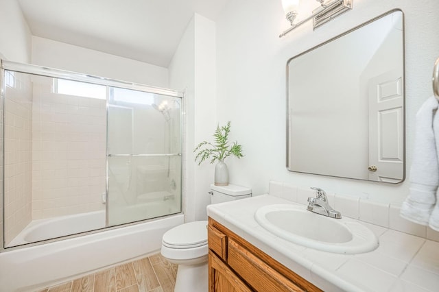 6355 N Cleo Ave, Fresno, CA 93722 - full bathroom featuring vanity, shower / bath combination with glass door, and wood finished floors