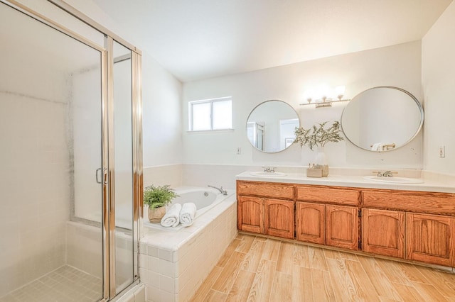 6355 N Cleo Ave, Fresno, CA 93722 - full bath featuring double vanity, a stall shower, a garden tub, and wood finished floors