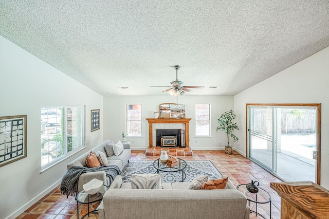 6355 N Cleo Ave, Fresno, CA 93722 - living room featuring plenty of natural light, light tile patterned floors, lofted ceiling, ceiling fan, and a textured ceiling