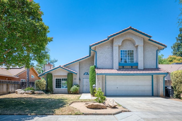 6355 N Cleo Ave, Fresno, CA 93722 - mediterranean / spanish house featuring stucco siding, a tile roof, an attached garage, concrete driveway, and a chimney