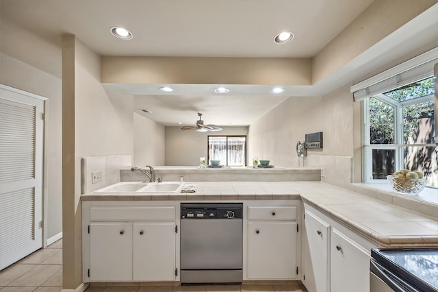 1702 W Bullard Unit 105, Fresno, CA 93711 - kitchen featuring stainless steel dishwasher, tile countertops, white cabinetry, a peninsula, and recessed lighting
