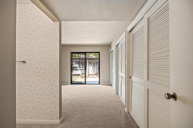 1702 W Bullard Unit 105, Fresno, CA 93711 - hall featuring carpet flooring and a textured ceiling