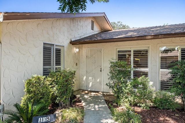 1702 W Bullard Unit 105, Fresno, CA 93711 - property entrance with a shingled roof and stucco siding