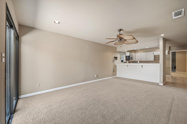 1702 W Bullard Unit 105, Fresno, CA 93711 - unfurnished living room featuring ceiling fan, light colored carpet, and recessed lighting