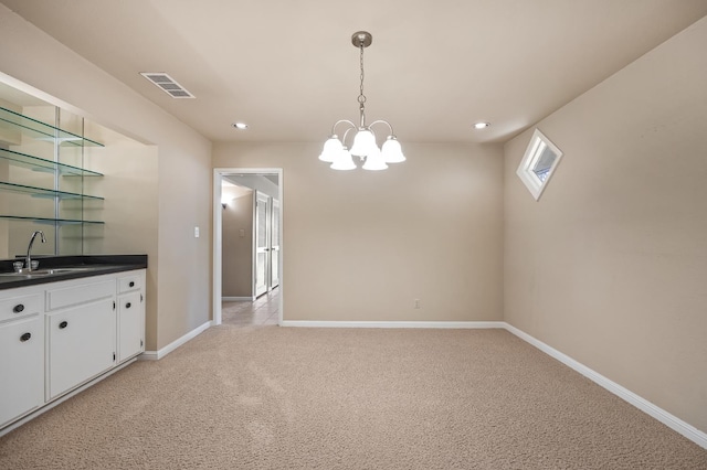 1702 W Bullard Unit 105, Fresno, CA 93711 - unfurnished dining area with light colored carpet, a chandelier, and recessed lighting