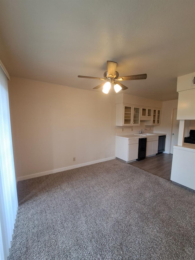 4919 N Millbrook Ave Unit 123, Fresno, CA 93726 - unfurnished living room featuring dark colored carpet and a ceiling fan