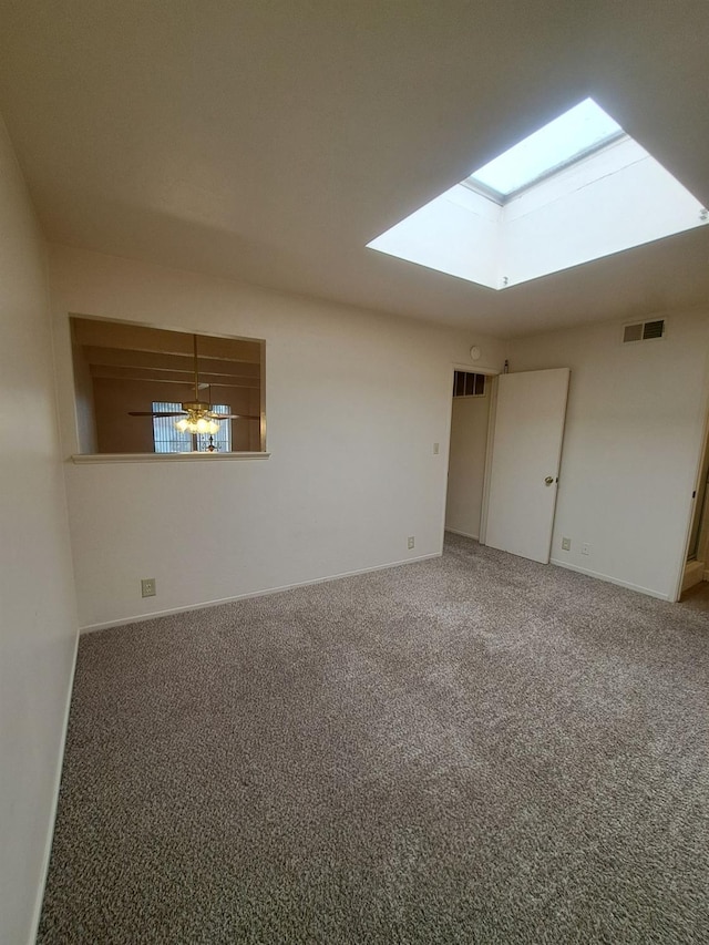 4919 N Millbrook Ave Unit 123, Fresno, CA 93726 - carpeted empty room featuring a skylight and baseboards