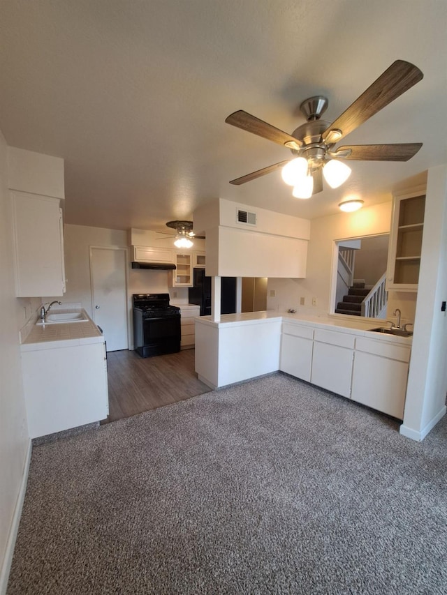 4919 N Millbrook Ave Unit 123, Fresno, CA 93726 - kitchen featuring black appliances, a ceiling fan, carpet, white cabinets, and light countertops