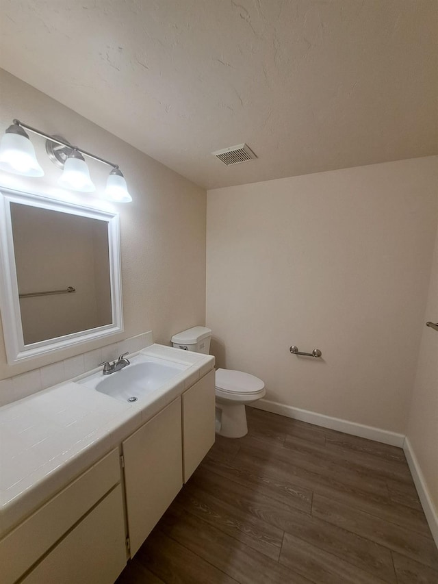 4919 N Millbrook Ave Unit 123, Fresno, CA 93726 - half bathroom with vanity and wood finished floors
