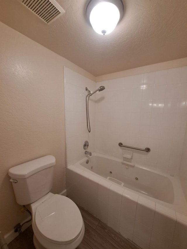 4919 N Millbrook Ave Unit 123, Fresno, CA 93726 - full bath with a textured ceiling, a combined bath / shower with jetted tub, and wood finished floors