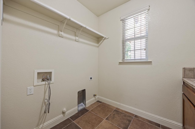 5929 N La Paz Ave, Fresno, CA 93723 - washroom with hookup for a gas dryer, washer hookup, hookup for an electric dryer, and dark tile patterned floors