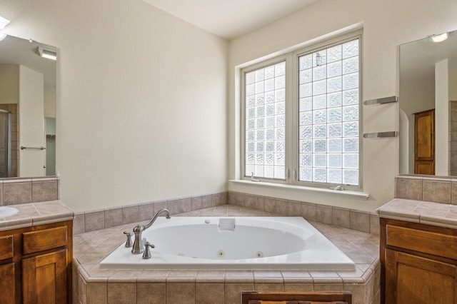 5929 N La Paz Ave, Fresno, CA 93723 - full bathroom featuring vanity, healthy amount of natural light, a jetted tub, and a shower stall