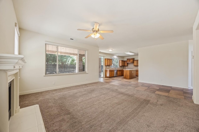 5929 N La Paz Ave, Fresno, CA 93723 - unfurnished living room with ceiling fan, light carpet, and a fireplace with flush hearth