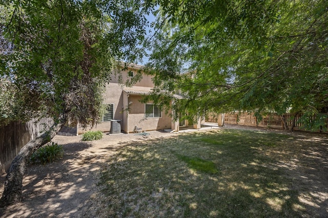 5929 N La Paz Ave, Fresno, CA 93723 - back of house with stucco siding, a fenced backyard, and a tiled roof