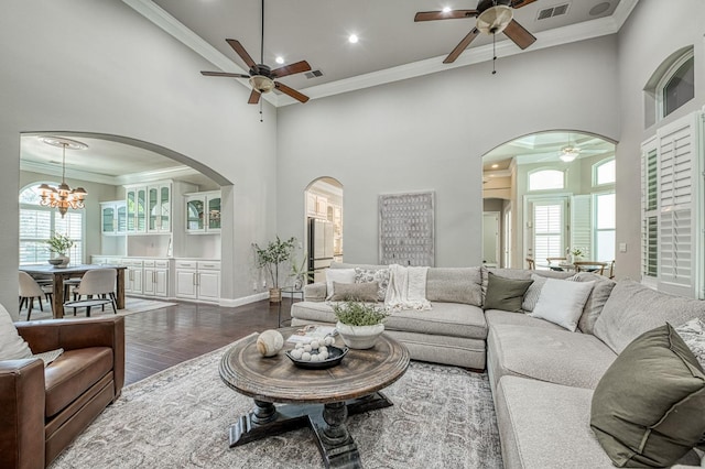 218 W Hubert Ct, Fresno, CA 93711 - living room with ceiling fan, arched walkways, dark wood-type flooring, a high ceiling, and crown molding
