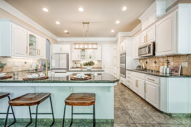 218 W Hubert Ct, Fresno, CA 93711 - kitchen with stainless steel appliances, a peninsula, a kitchen breakfast bar, glass insert cabinets, and tasteful backsplash