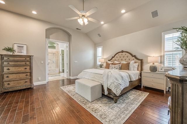 218 W Hubert Ct, Fresno, CA 93711 - bedroom featuring multiple windows, dark wood-style floors, arched walkways, vaulted ceiling, and connected bathroom