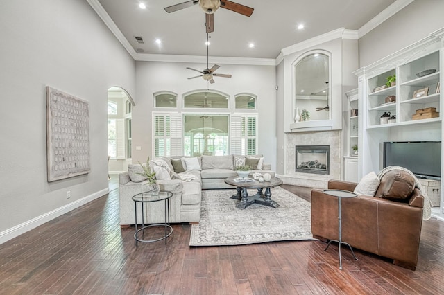 218 W Hubert Ct, Fresno, CA 93711 - living area featuring a ceiling fan, crown molding, arched walkways, a fireplace, and dark wood finished floors