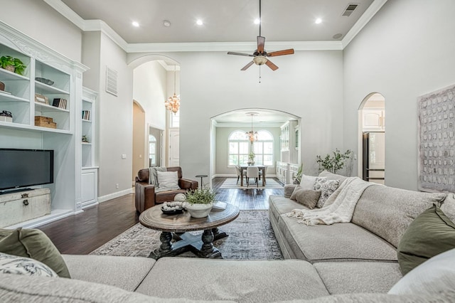 218 W Hubert Ct, Fresno, CA 93711 - living area featuring arched walkways, wood finished floors, a towering ceiling, crown molding, and recessed lighting