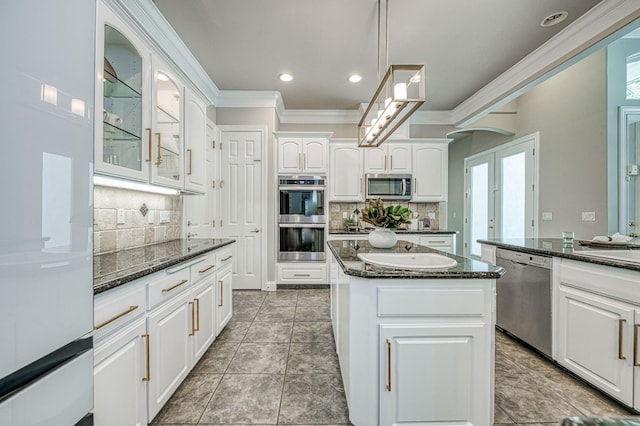 218 W Hubert Ct, Fresno, CA 93711 - kitchen with stainless steel appliances, ornamental molding, backsplash, white cabinets, and glass insert cabinets