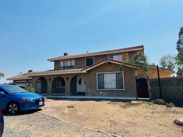 16474 Karen Rd, Madera, CA 93636 - mediterranean / spanish-style home featuring a porch, stucco siding, a chimney, and a tiled roof