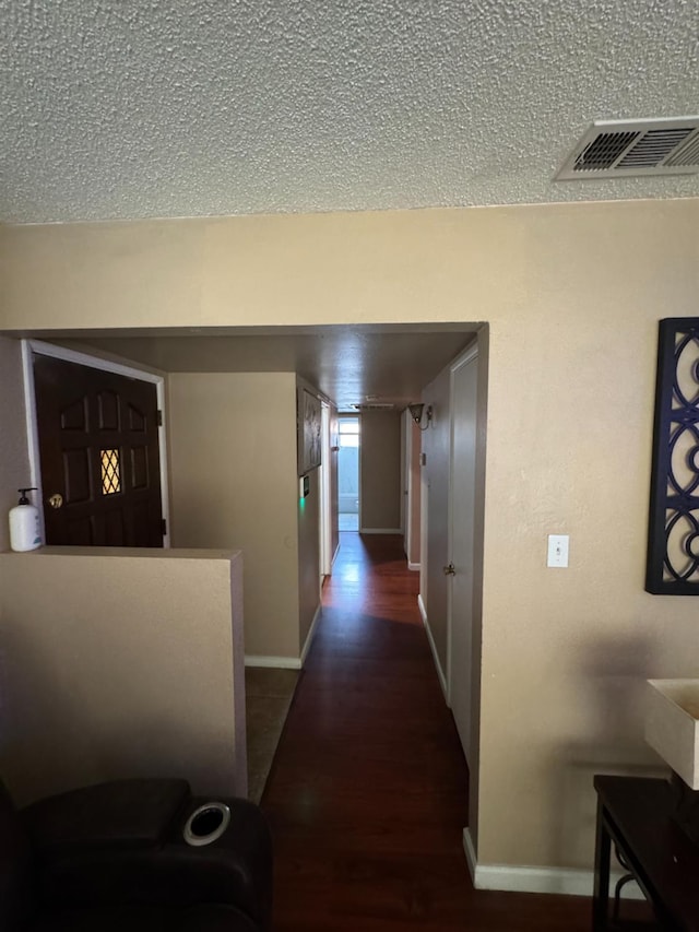 4615 E Hamilton Ave E, Fresno, CA 93702 - hallway featuring dark wood-style floors and a textured ceiling