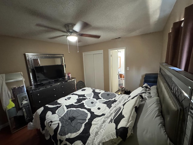 4615 E Hamilton Ave E, Fresno, CA 93702 - bedroom featuring a closet, a textured ceiling, ceiling fan, and wood finished floors
