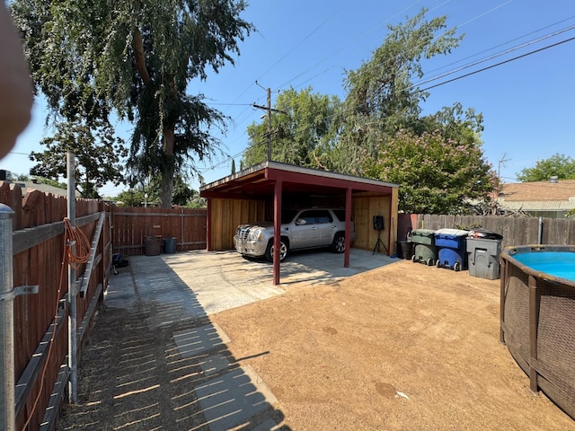4615 E Hamilton Ave E, Fresno, CA 93702 - view of car parking with a fenced backyard, driveway, and an attached carport