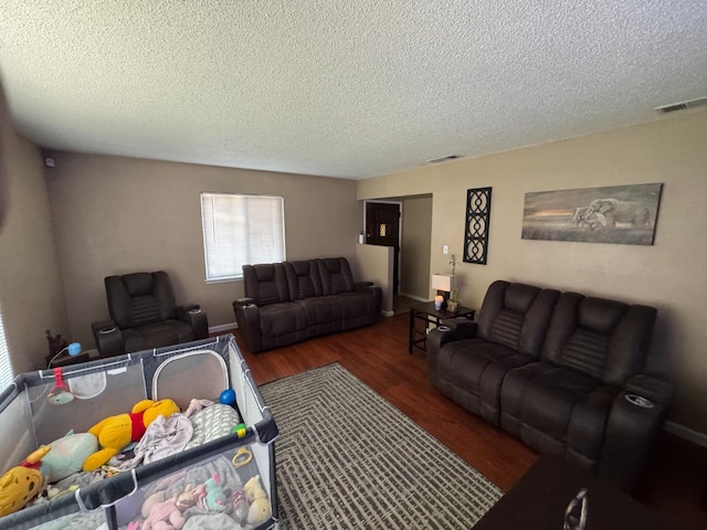 4615 E Hamilton Ave E, Fresno, CA 93702 - living area featuring a textured ceiling and wood finished floors
