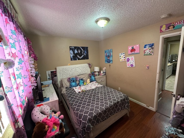 4615 E Hamilton Ave E, Fresno, CA 93702 - bedroom featuring wood finished floors and a textured ceiling