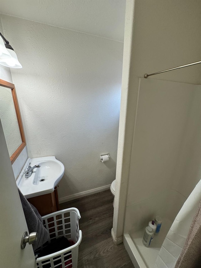 4615 E Hamilton Ave E, Fresno, CA 93702 - bathroom featuring a shower stall, wood finished floors, and vanity