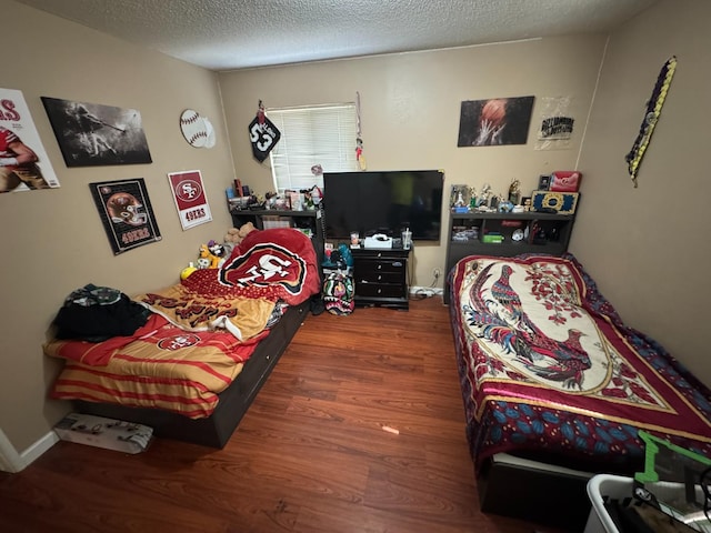 4615 E Hamilton Ave E, Fresno, CA 93702 - bedroom featuring wood finished floors and a textured ceiling