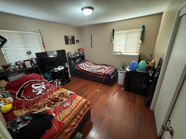 4615 E Hamilton Ave E, Fresno, CA 93702 - bedroom with wood finished floors and a textured ceiling