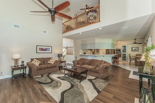 4950 W Minarets Ave, Fresno, CA 93722 - living room featuring a ceiling fan, wood finished floors, and a high ceiling