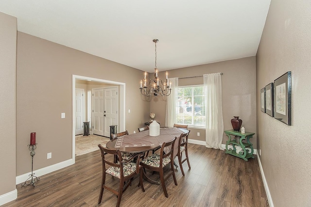 4950 W Minarets Ave, Fresno, CA 93722 - dining room featuring dark wood-style flooring, a chandelier, and a textured wall