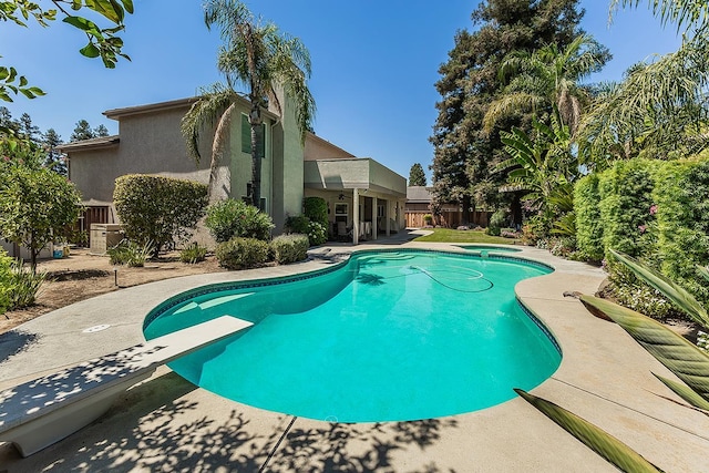 4950 W Minarets Ave, Fresno, CA 93722 - view of swimming pool with a patio area, a diving board, and a pool with connected hot tub