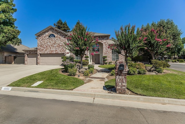 4950 W Minarets Ave, Fresno, CA 93722 - view of front of house featuring concrete driveway, a front lawn, and stone siding