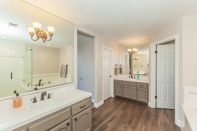 4950 W Minarets Ave, Fresno, CA 93722 - full bathroom featuring a chandelier, vanity, a garden tub, and a stall shower