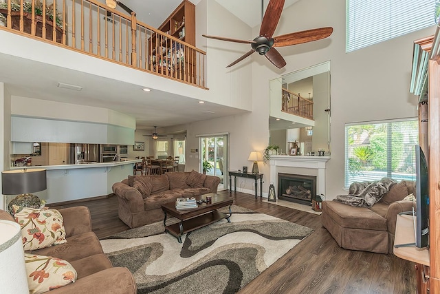 4950 W Minarets Ave, Fresno, CA 93722 - living area featuring a ceiling fan, a high ceiling, wood finished floors, a glass covered fireplace, and recessed lighting
