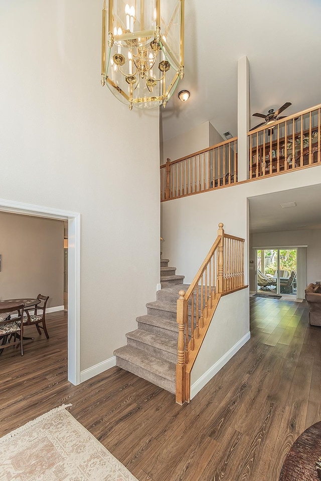 4950 W Minarets Ave, Fresno, CA 93722 - stairs with a towering ceiling, wood finished floors, ceiling fan, and a chandelier