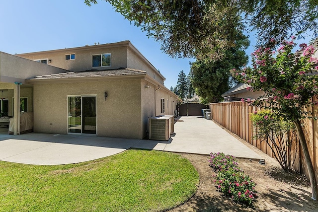 4950 W Minarets Ave, Fresno, CA 93722 - rear view of house with stucco siding, a patio area, and a storage shed