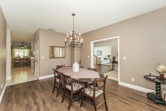 4950 W Minarets Ave, Fresno, CA 93722 - dining room featuring a chandelier and dark wood-style flooring