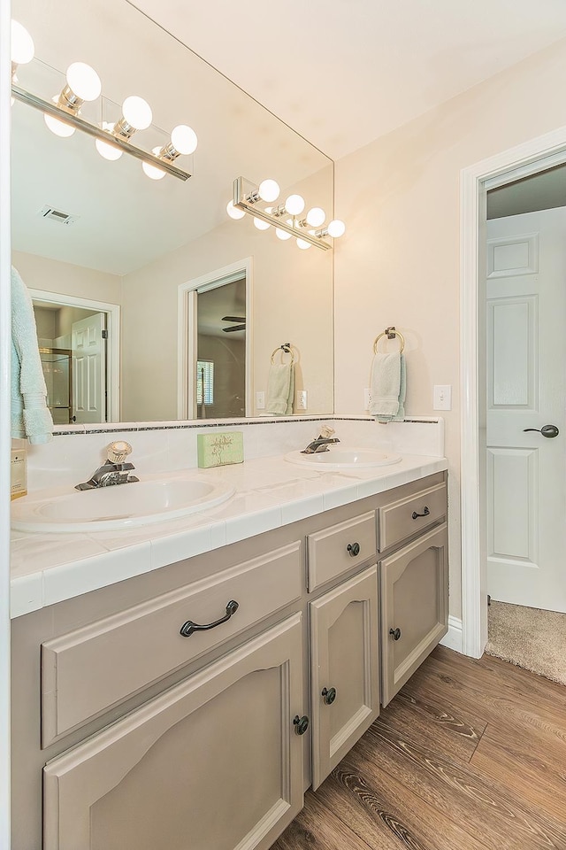 4950 W Minarets Ave, Fresno, CA 93722 - full bath featuring double vanity and wood finished floors