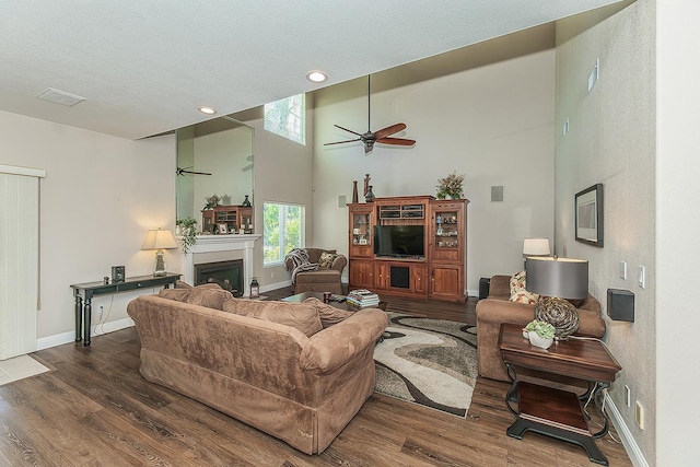 4950 W Minarets Ave, Fresno, CA 93722 - living room with a ceiling fan, wood finished floors, a high ceiling, a fireplace, and recessed lighting