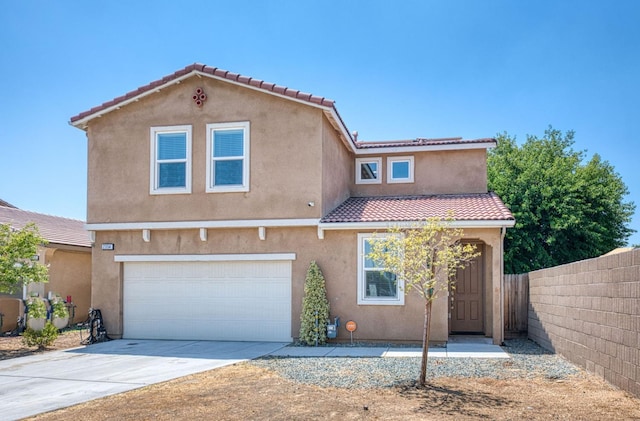 2354 S Garden, Fresno, CA 93725 - mediterranean / spanish home with an attached garage, stucco siding, concrete driveway, and a tile roof