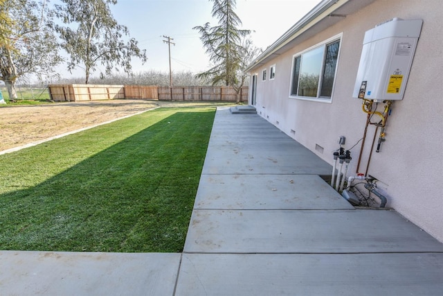 5942 S Cedar Ave, Fresno, CA 93725 - view of yard featuring tankless water heater and a patio