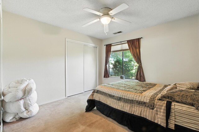 36358 Orange Grove Ave, Madera, CA 93636 - bedroom featuring carpet floors, a closet, a textured ceiling, and a ceiling fan