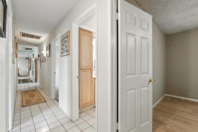 36358 Orange Grove Ave, Madera, CA 93636 - corridor featuring a textured ceiling and light tile patterned flooring