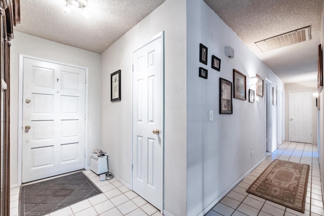 36358 Orange Grove Ave, Madera, CA 93636 - hallway with light tile patterned floors and a textured ceiling